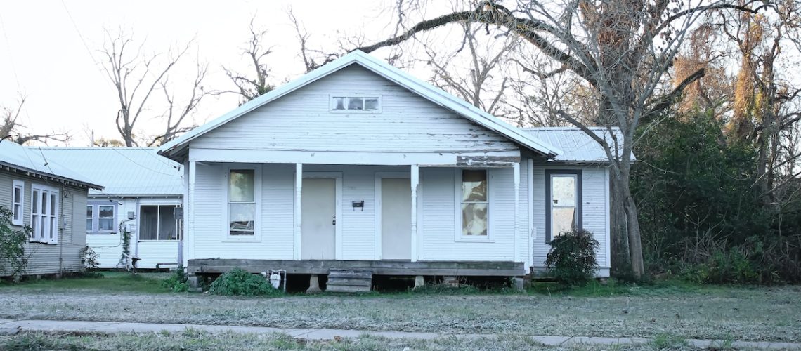 Alexandria, Louisiana United States - December 26 2020: an old white house at an awkward angle