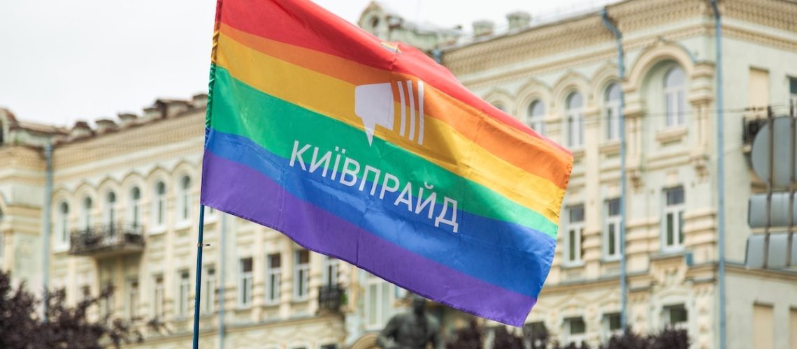 Kyiv, Ukraine - 09.19.2021: Pride Parade. Participants of the march walk the streets of the city with a rainbow flag. A crowd of young people. Concept LGBTQ.