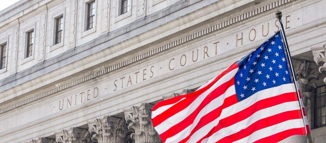 USA national flag waving in the wind in front of United States Court House in New York