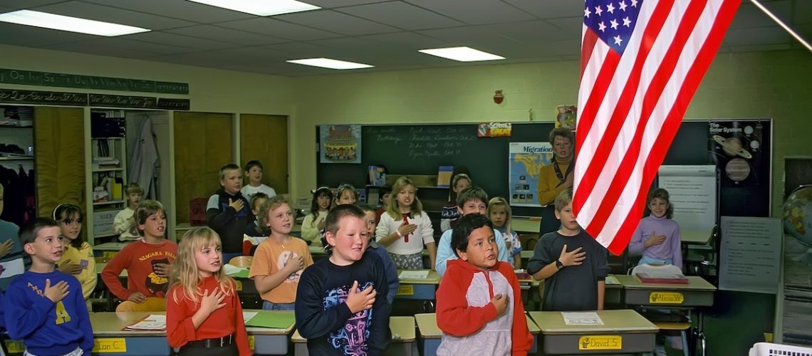 Third grade elementary school class recites the pledge of allegiance to the american flag every morning before beginning studies. created 05.12.2023