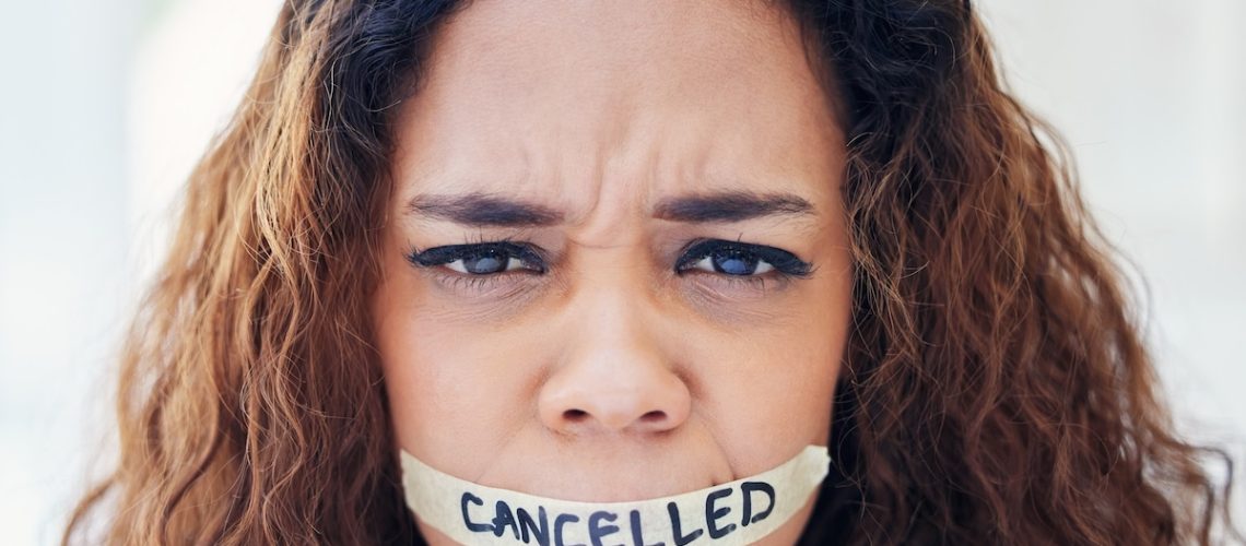 Woman, portrait and tape on mouth for violence with political, protest and feminism movement for justice. Activism, victim and person with censor and cancel culture, harassment and freedom of speech